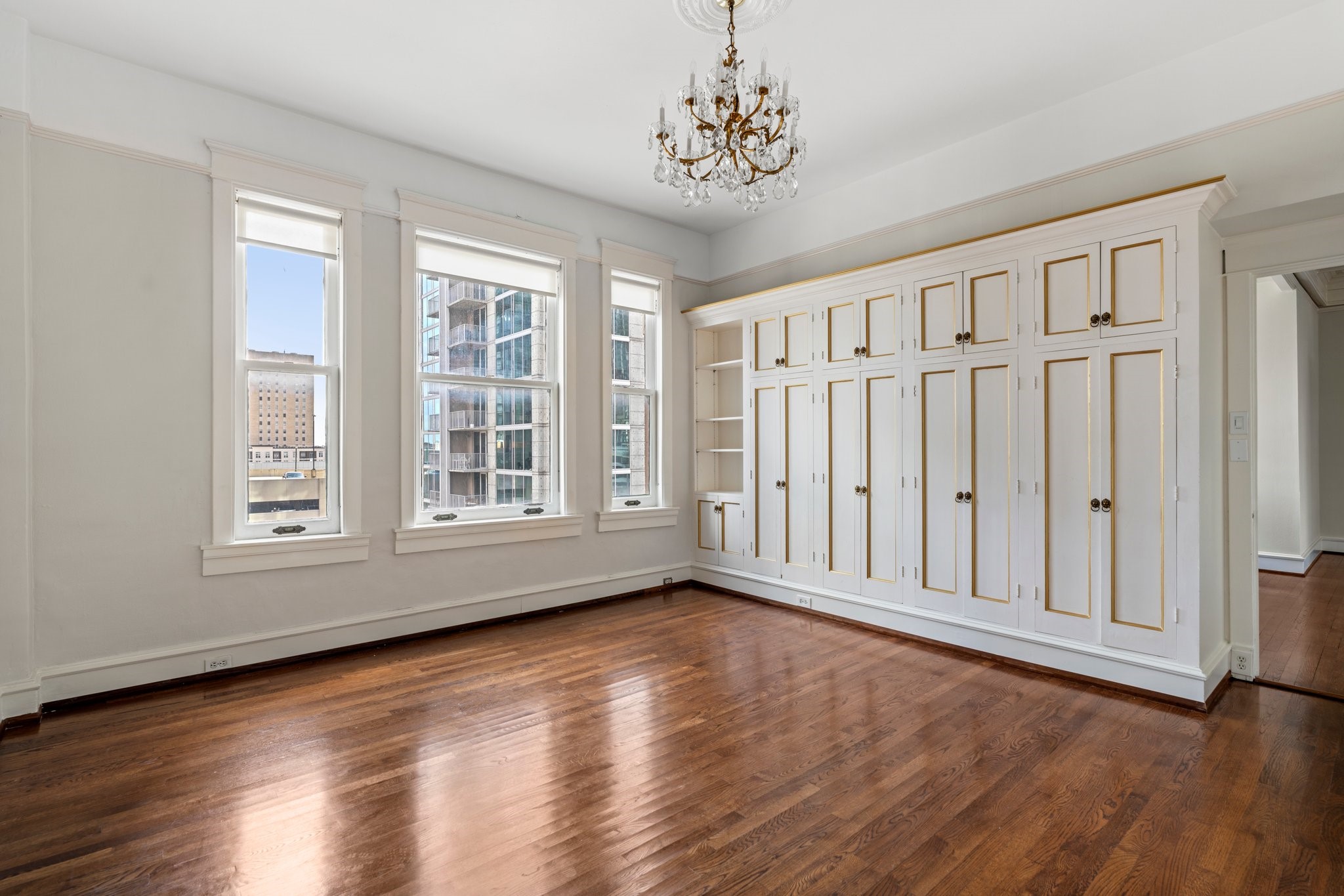 1700 Main Street, Unit 7B Houston, TX 77002 - Photo 5 of 50 a view of an empty room with wooden floor and a window