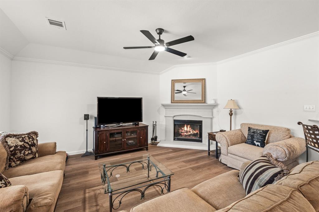 205 Crepe Myrtle Lane Murphy, TX 75094 - Photo 13 of 33 a living room with furniture a flat screen tv and a fireplace