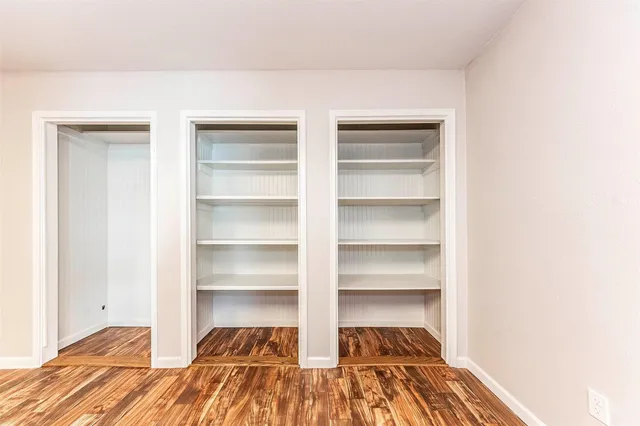a view of walk in closet with empty racks