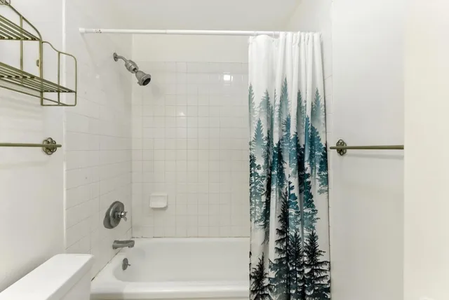 a bathroom with a shower curtain and a sink