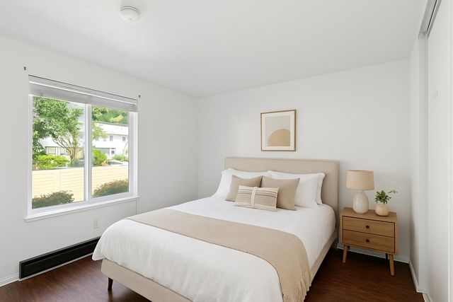 a bedroom with a bed and a window