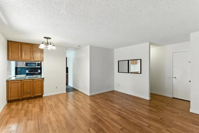 a view of a kitchen with a sink and a refrigerator