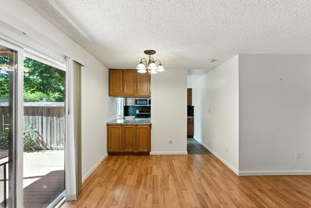 a view of a kitchen with wooden floor and a kitchen