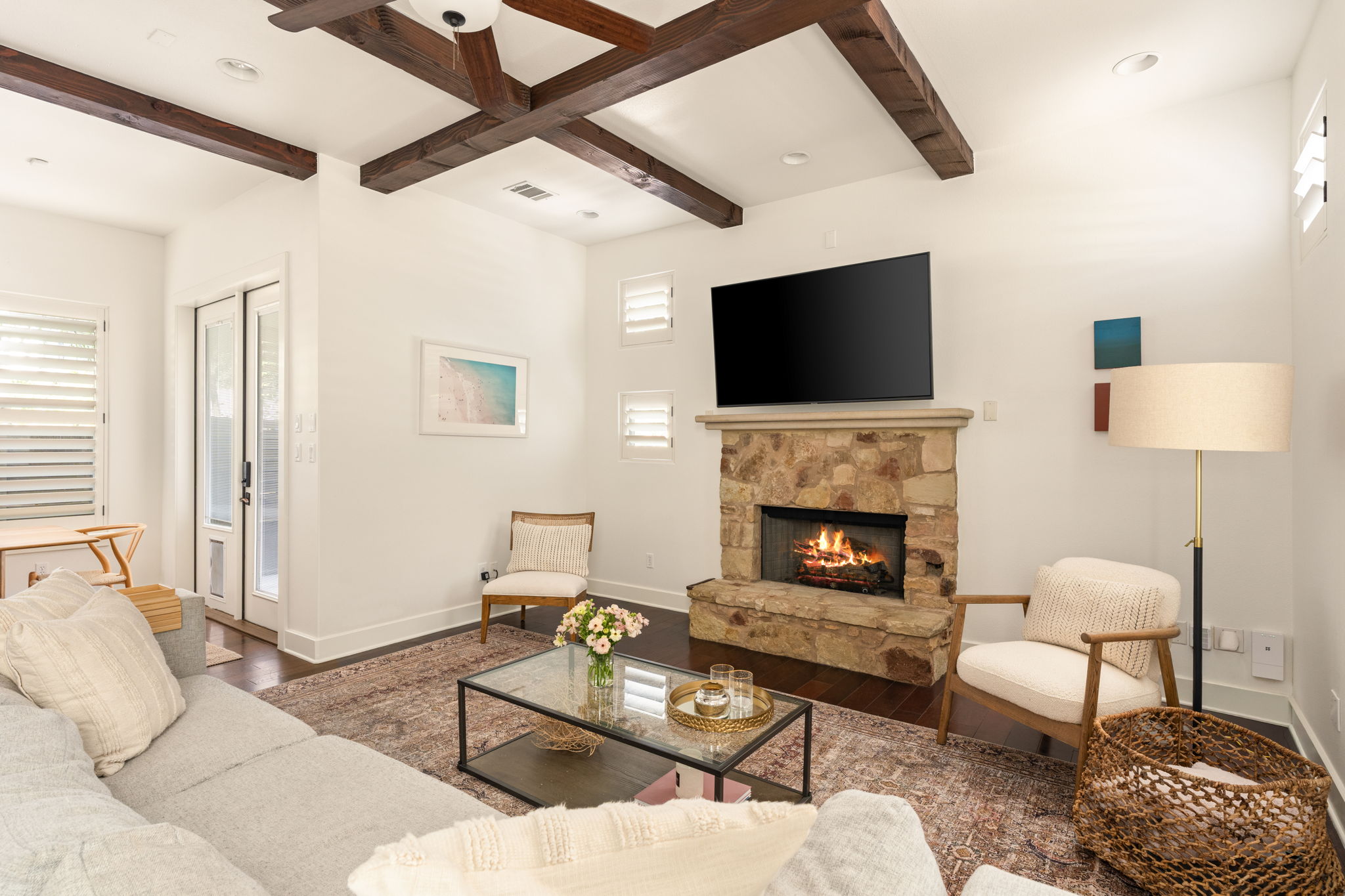 2324 Kinney Road Austin, TX 78704 - Photo 6 of 35 Rich exposed ceiling beams and a stone fireplace anchor this warm living space.
