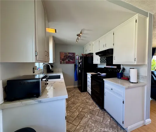 a kitchen with a sink a stove and refrigerator