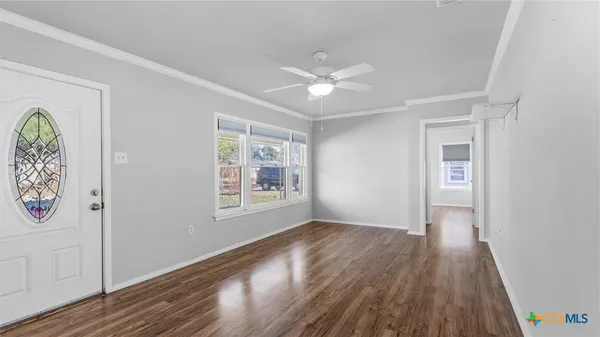 wooden floor in an empty room with a window