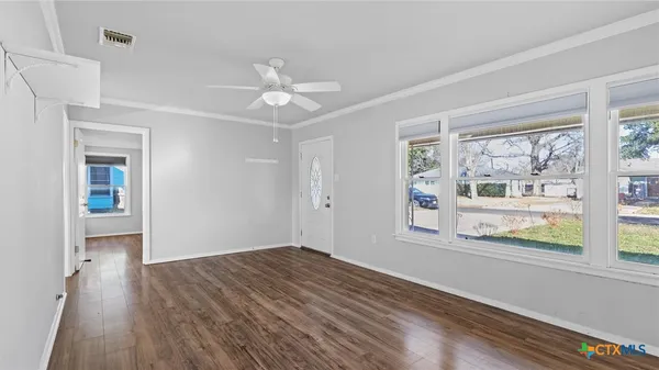 wooden floor in an empty room with a window
