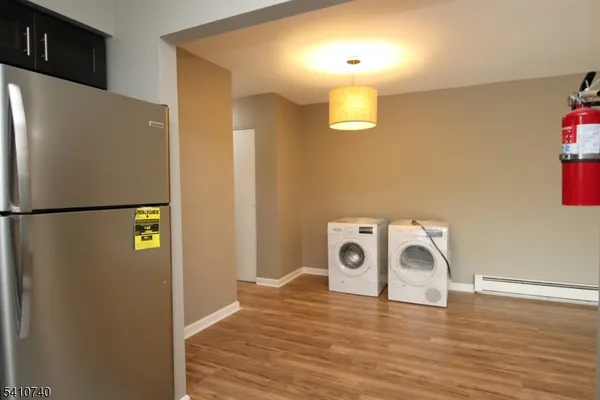 a view of a kitchen with a refrigerator a microwave and a floor to ceiling window