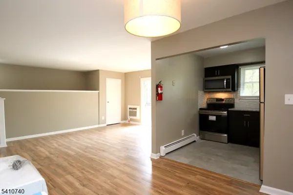 a view of a kitchen with a sink and a refrigerator