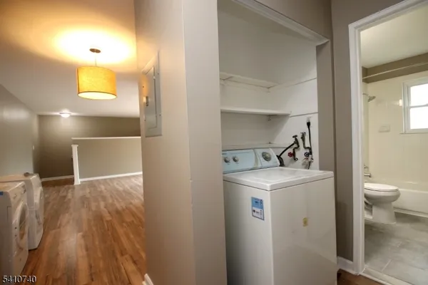 a view of hallway with wooden floor