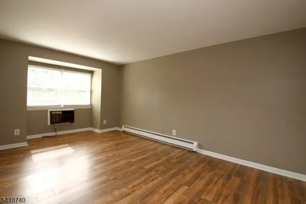 an empty room with a fireplace and windows