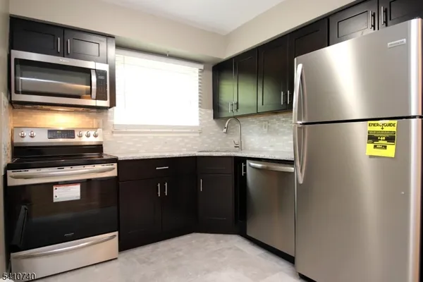 a kitchen with a refrigerator and a sink