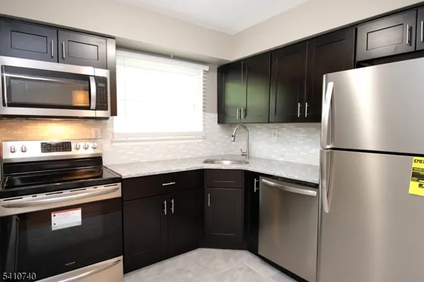 a kitchen with a sink and stainless steel appliances