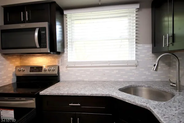 a kitchen with a sink and a microwave