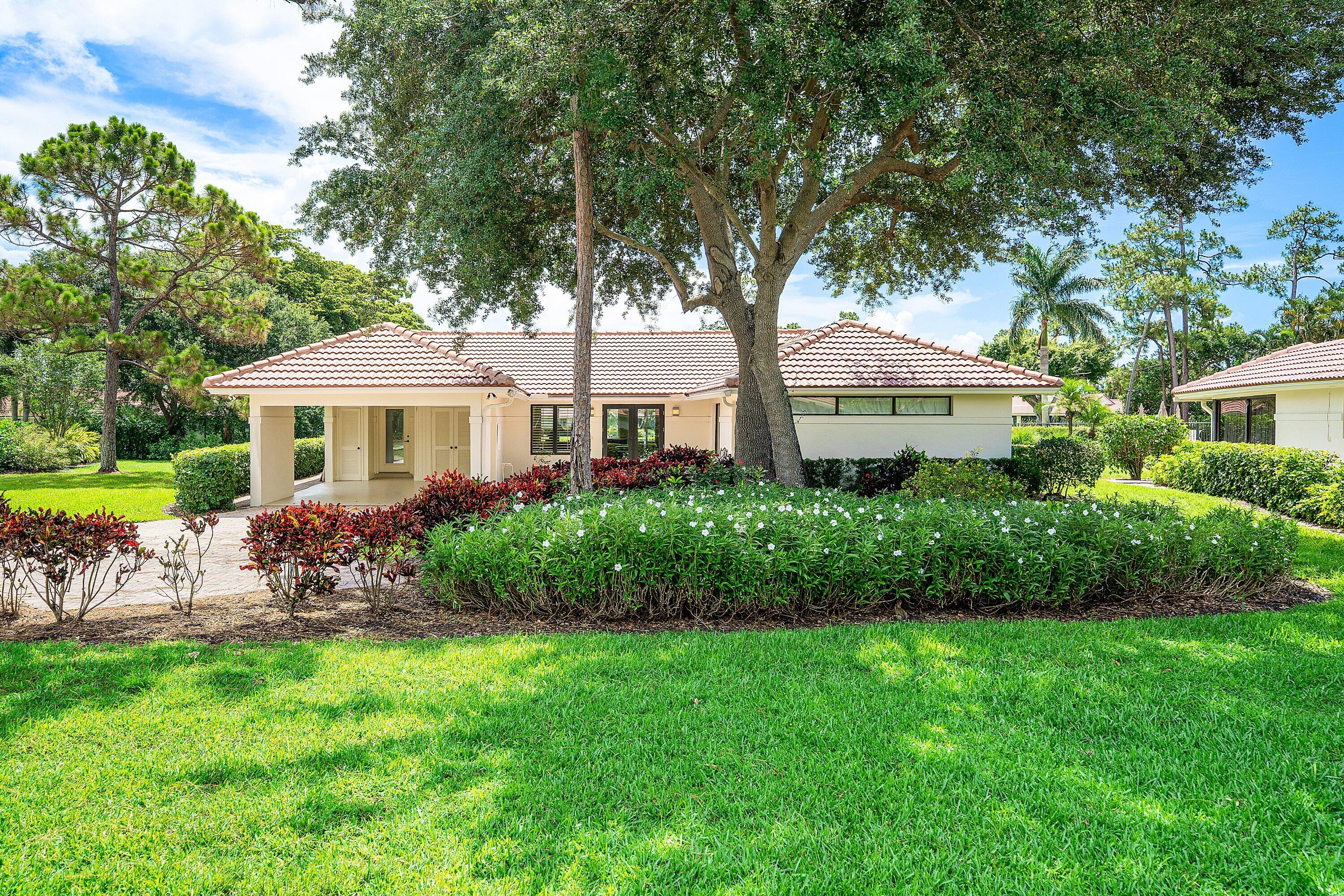 4365 Shell Drake Lane Boynton Beach, FL 33436 - Photo 45 of 56 a front view of a house with garden
