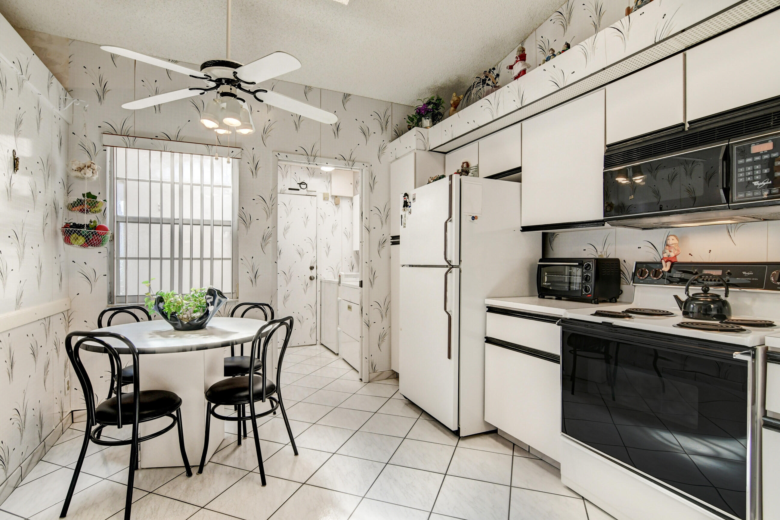 6359 Mill Pointe Circle Delray Beach, FL 33484 - Photo 24 of 57 Kitchen leading to the Laundry room