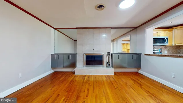 a view of empty room with wooden floor