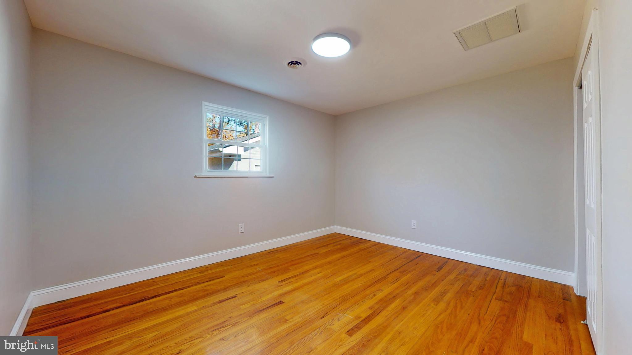 119 East Collings Drive Williamstown, NJ 08094 - Photo 24 of 61 an empty room with wooden floor and windows