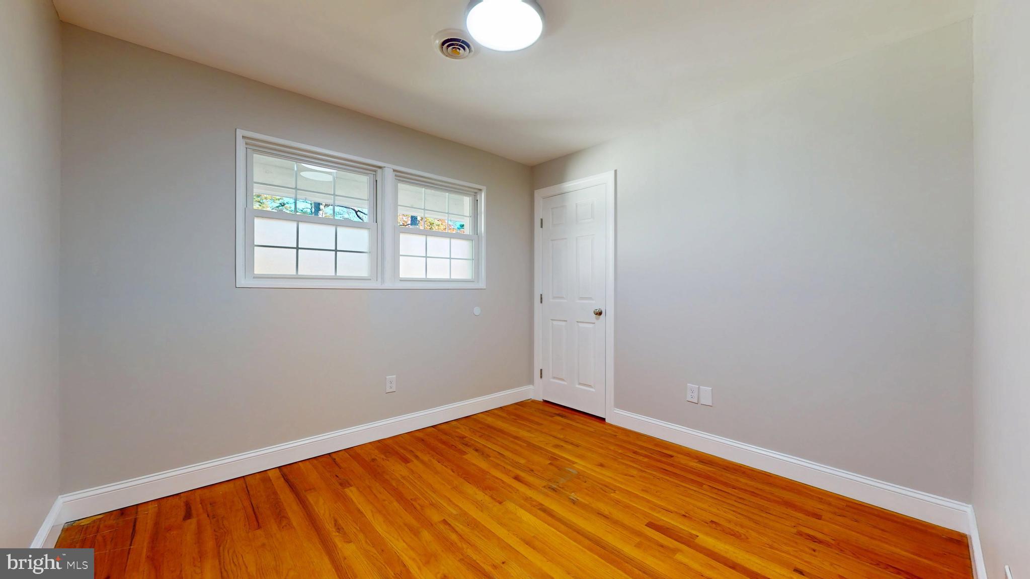 119 East Collings Drive Williamstown, NJ 08094 - Photo 25 of 61 an empty room with wooden floor and windows
