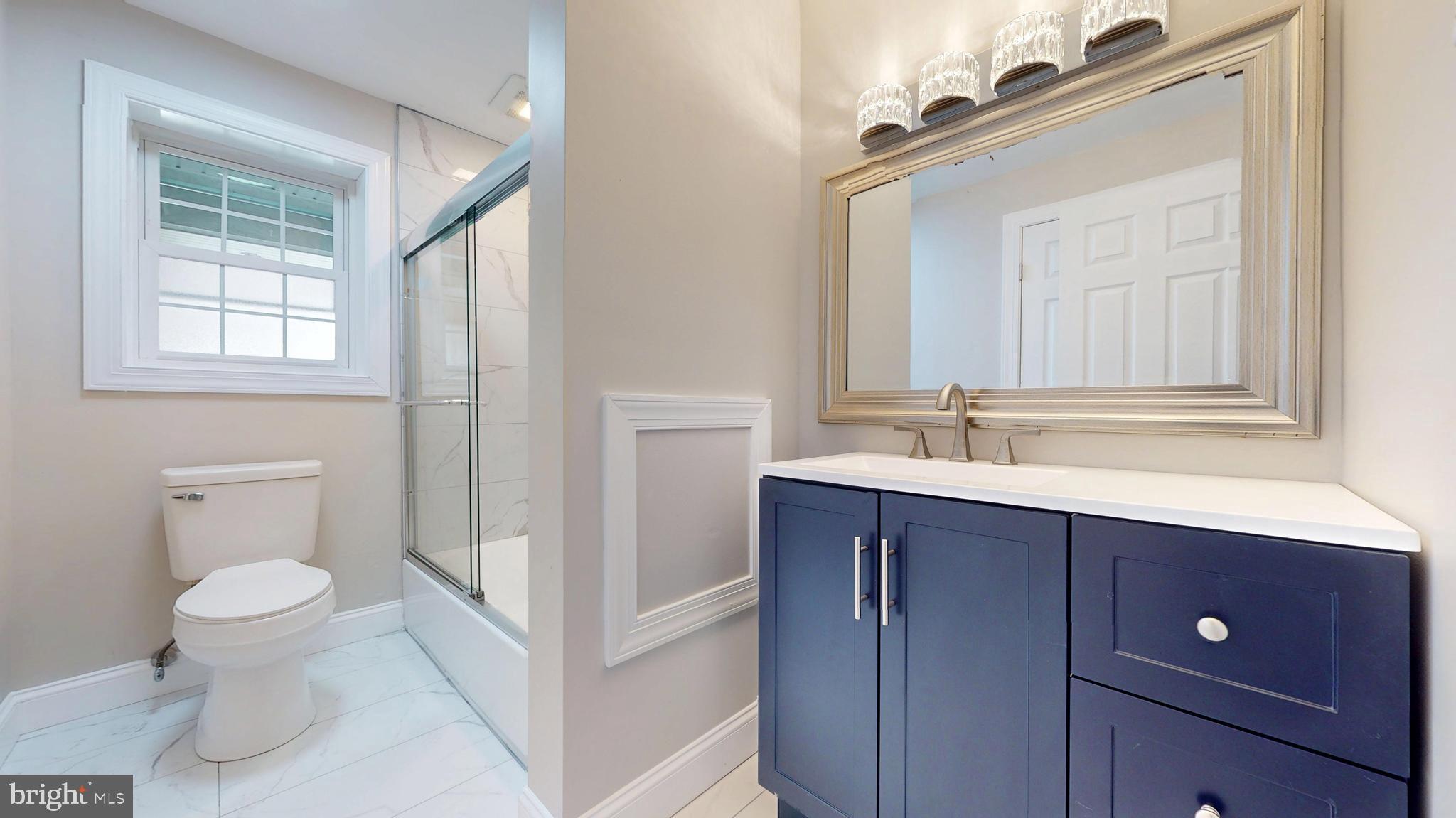 119 East Collings Drive Williamstown, NJ 08094 - Photo 30 of 61 a bathroom with a toilet a sink a mirror and a window