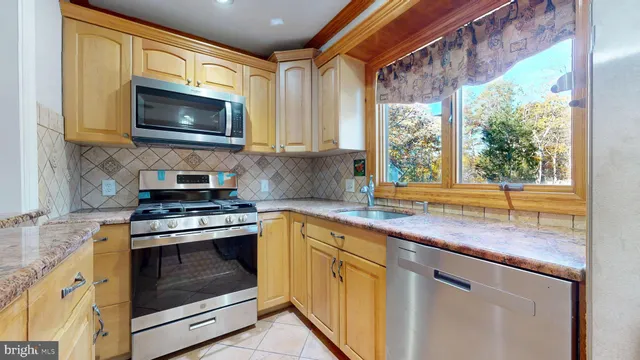 a kitchen with a stove microwave and sink