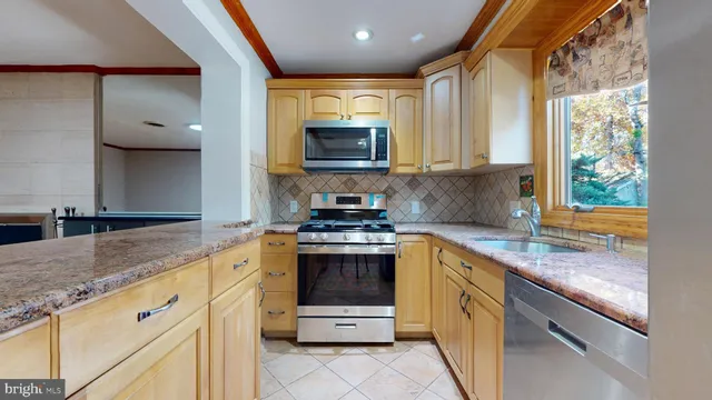 a kitchen with granite countertop a stove sink and microwave