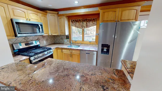 a kitchen with a refrigerator and a stove