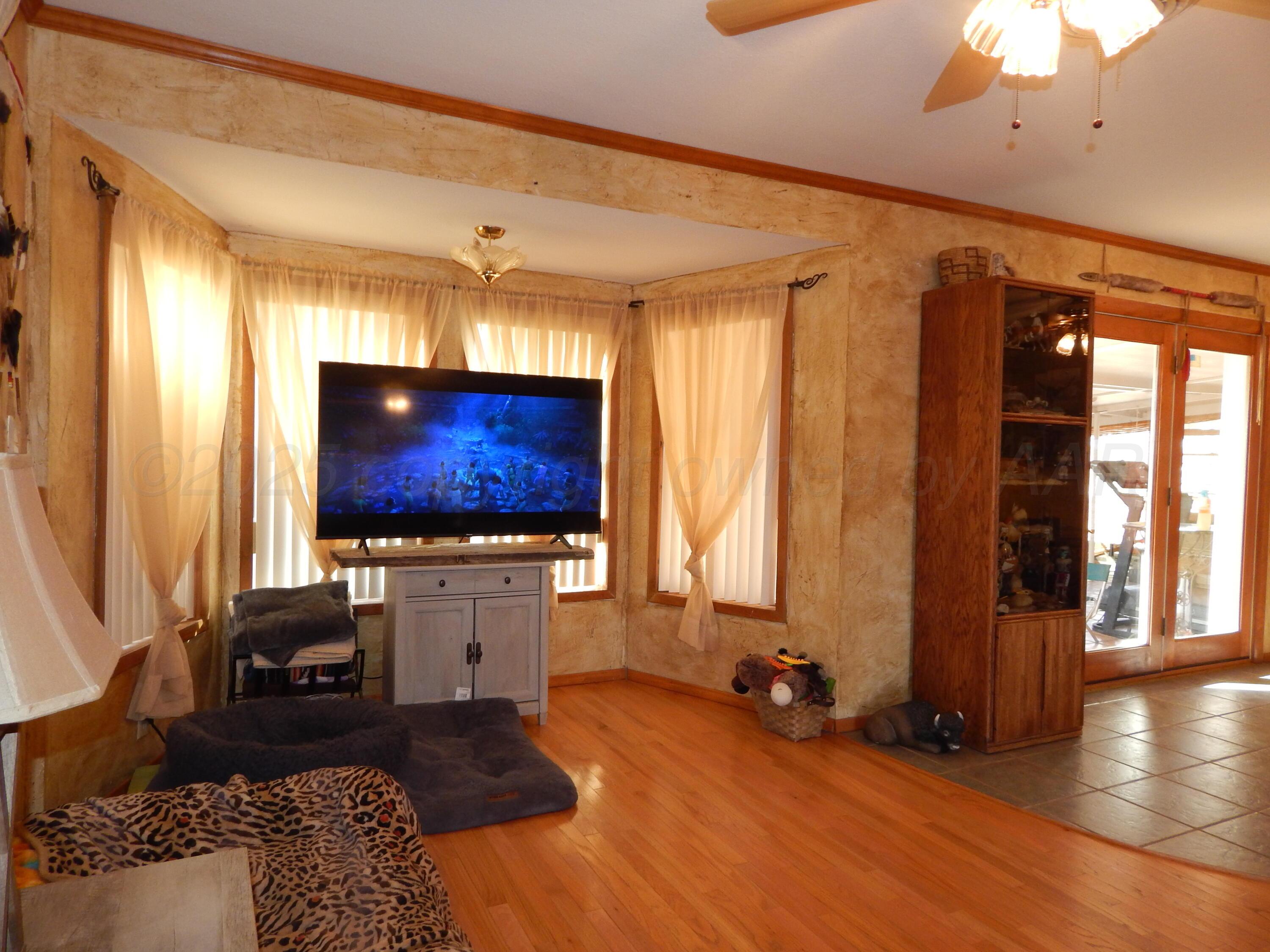 4205 Highway 83 Wellington, TX 79095 - Photo 20 of 52 a living room with furniture and a flat screen tv