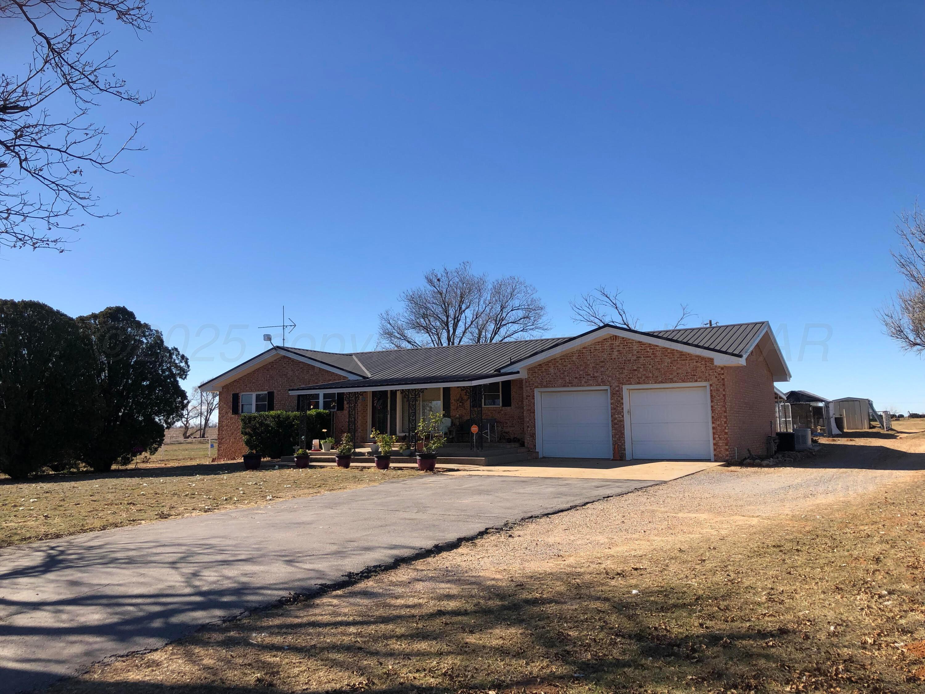 4205 Highway 83 Wellington, TX 79095 - Photo 2 of 52 a front view of a house with a yard