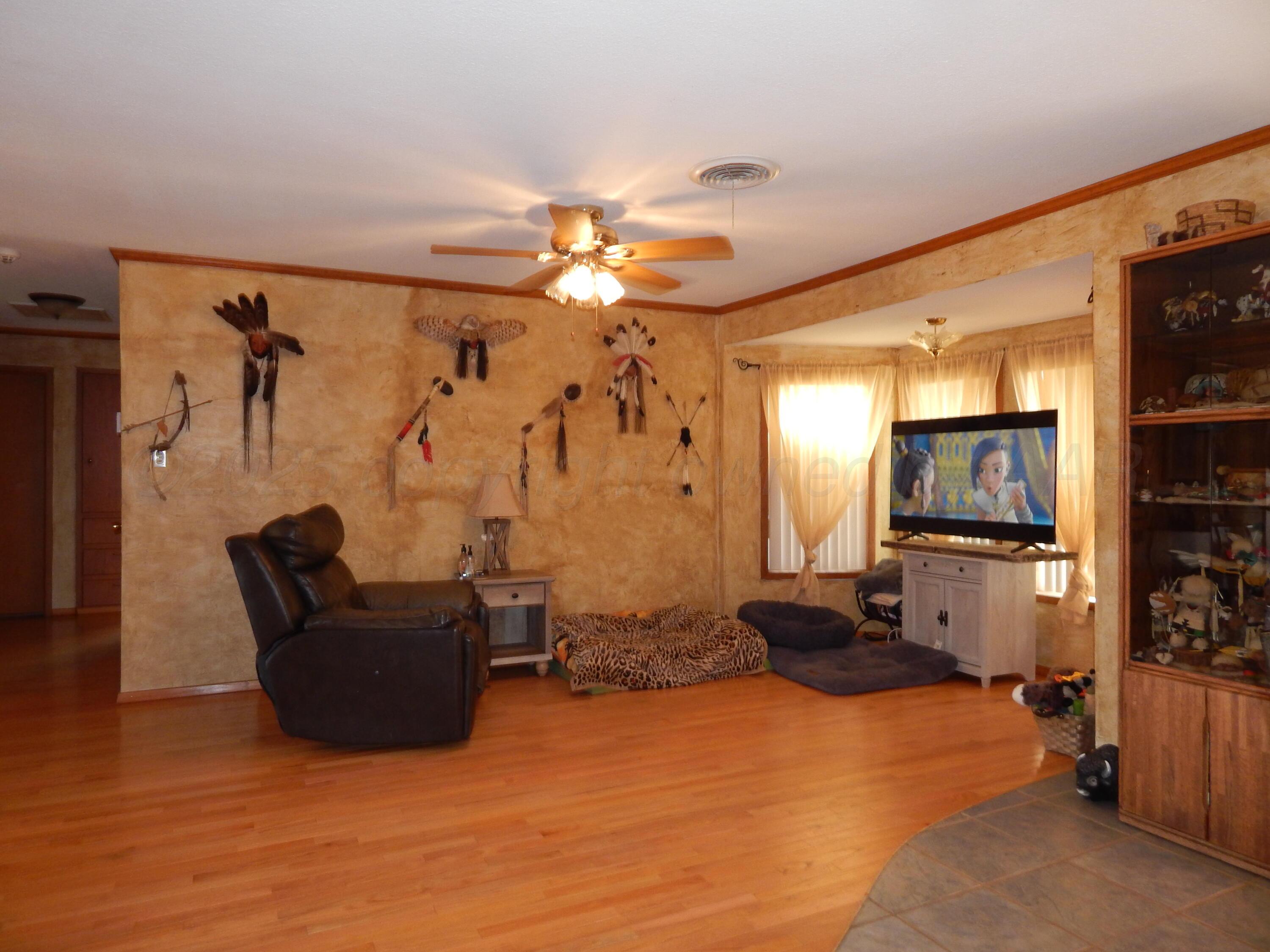 4205 Highway 83 Wellington, TX 79095 - Photo 21 of 52 a living room with furniture and a flat screen tv