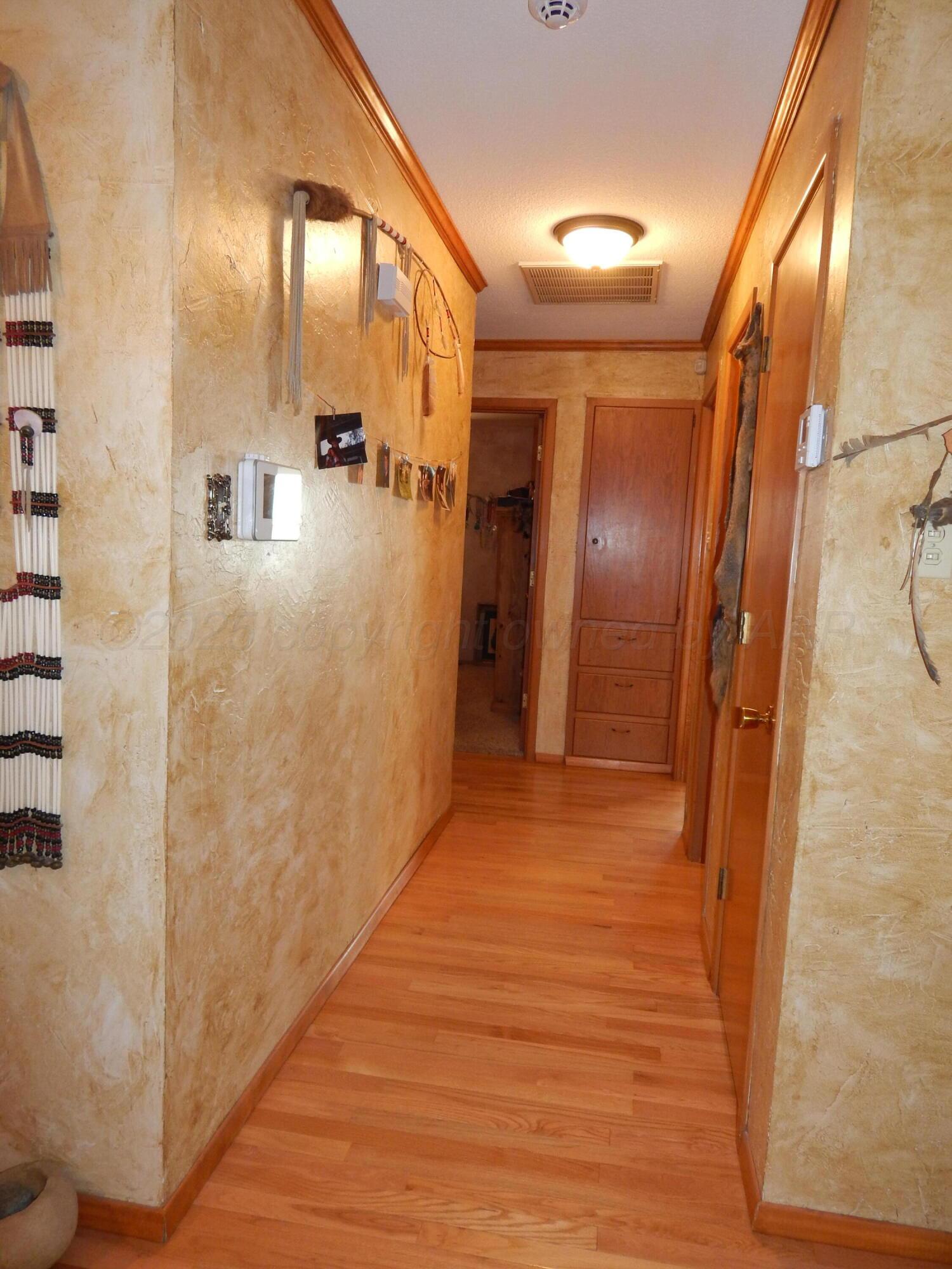 4205 Highway 83 Wellington, TX 79095 - Photo 22 of 52 a view of a hallway with wooden floor