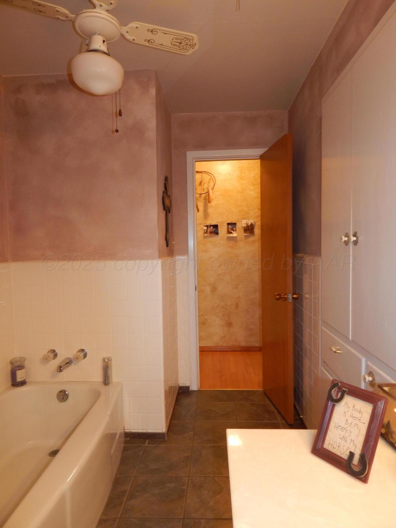 4205 Highway 83 Wellington, TX 79095 - Photo 25 of 52 a bathroom with a tub shower and sink