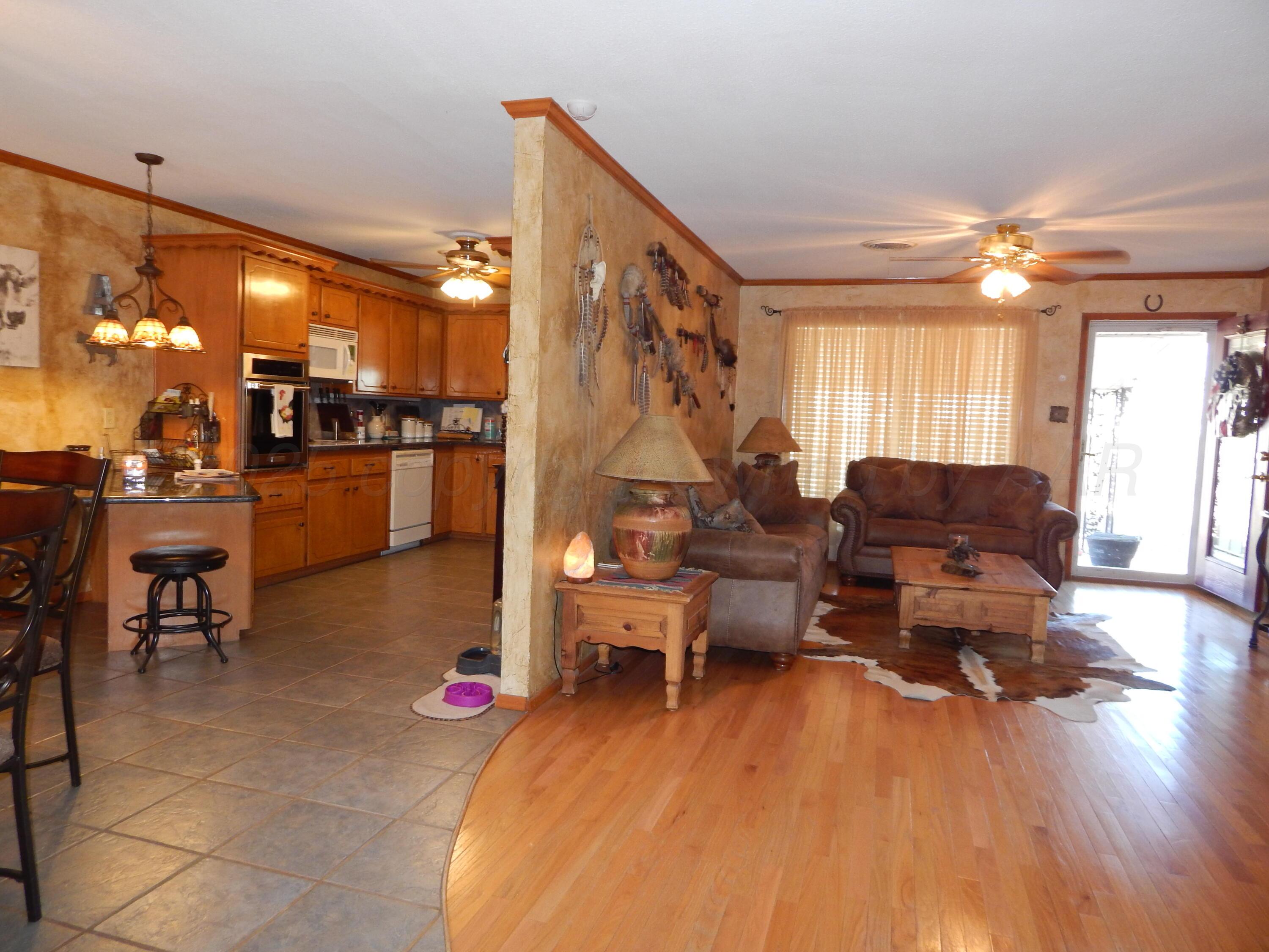 4205 Highway 83 Wellington, TX 79095 - Photo 37 of 52 a living room with furniture and a chandelier