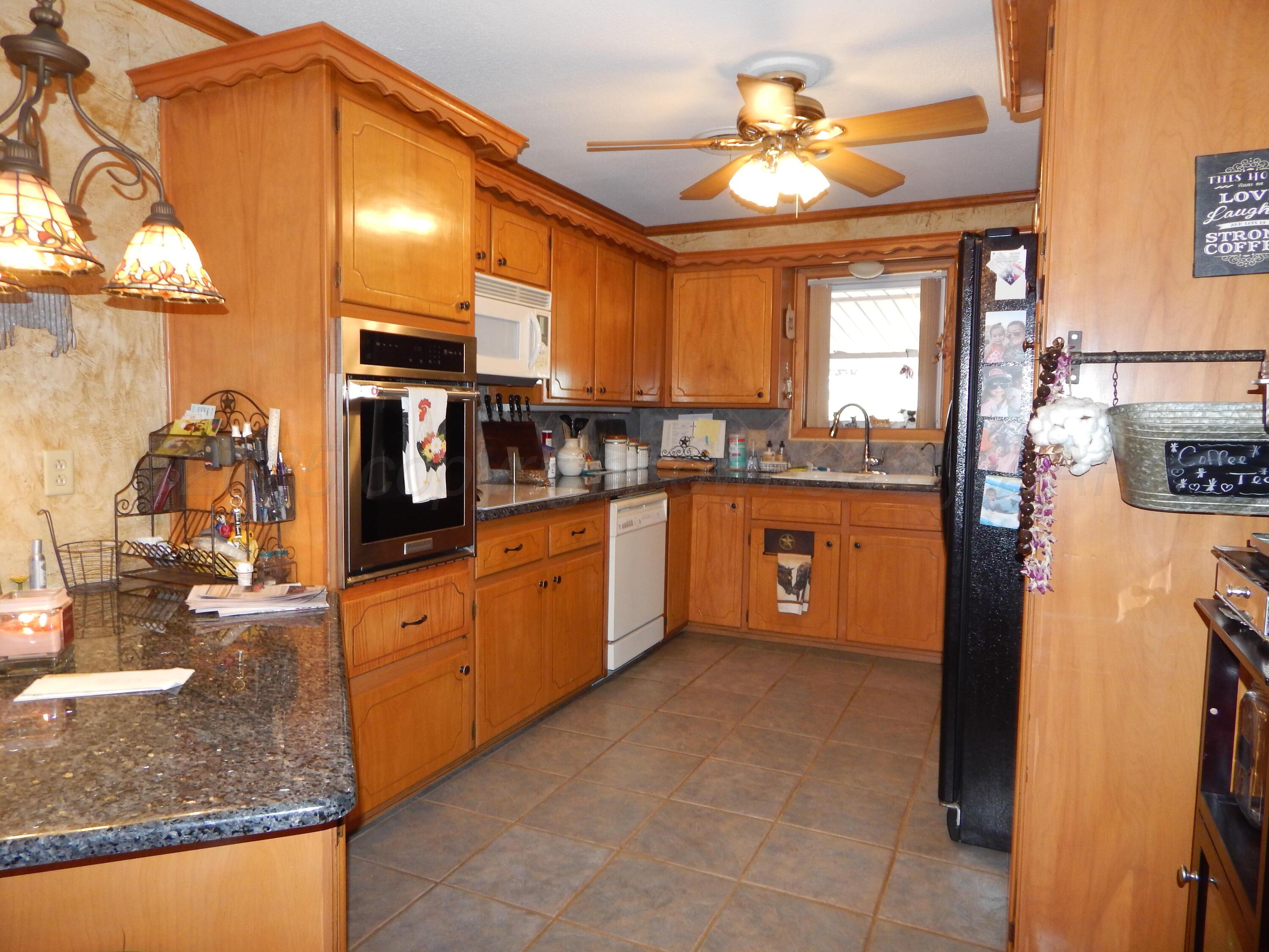 4205 Highway 83 Wellington, TX 79095 - Photo 9 of 52 a kitchen with stainless steel appliances granite countertop a sink and cabinets