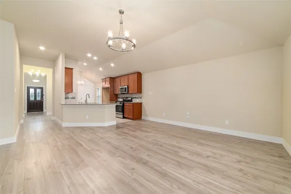 a view of a kitchen with a sink and a refrigerator