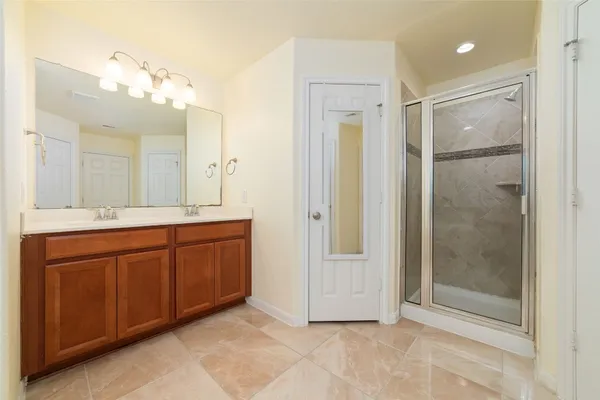 a bathroom with a shower sink and mirror