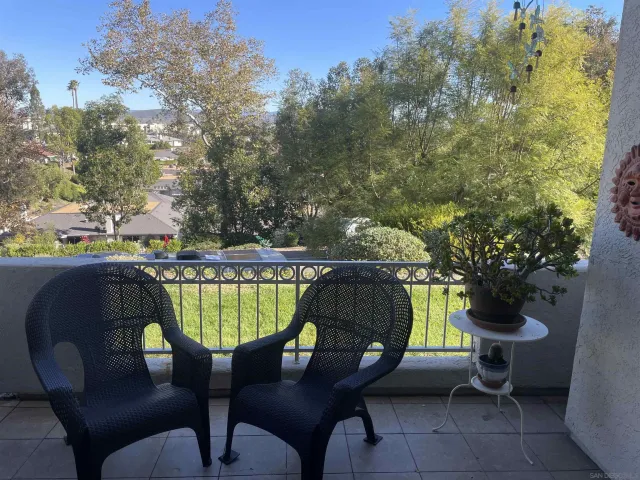 a swimming pool with outdoor seating and trees