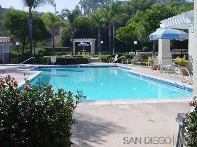 a view of a swimming pool with chairs