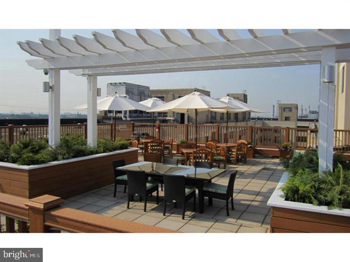 3131 Walnut Street, Unit 0B654 Philadelphia, PA 19104 - Photo 7 of 9 a view of a patio with chairs and tables