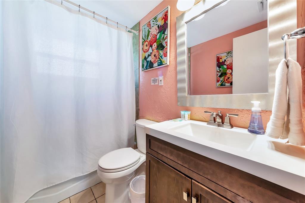 5948 Mirror Lake Road Sarasota, FL 34233 - Photo 11 of 50 a bathroom with a toilet a sink and a mirror