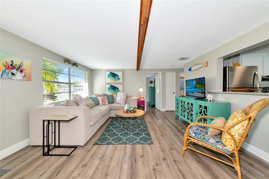 5948 Mirror Lake Road Sarasota, FL 34233 - Photo 20 of 50 a living room with furniture flat screen tv and a large window