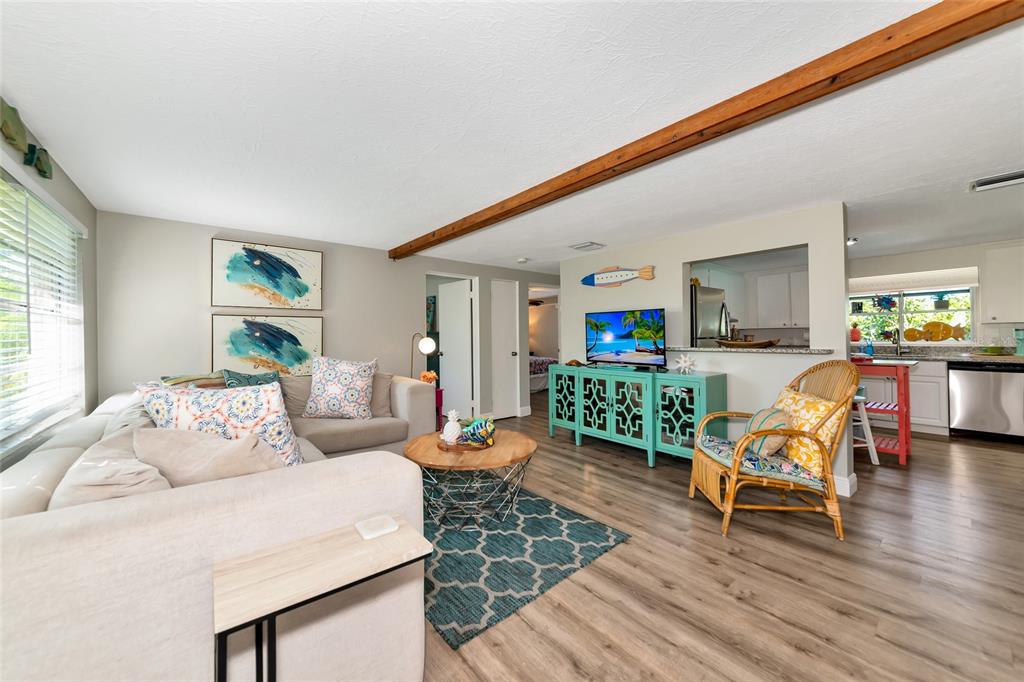 5948 Mirror Lake Road Sarasota, FL 34233 - Photo 21 of 50 a living room with furniture and wooden floor