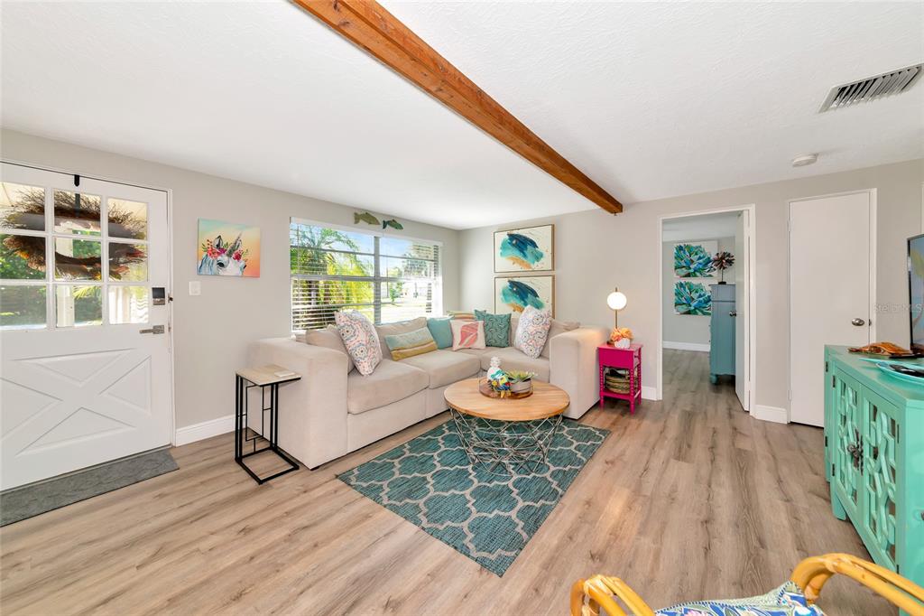 5948 Mirror Lake Road Sarasota, FL 34233 - Photo 22 of 50 a living room with furniture and a wooden floor