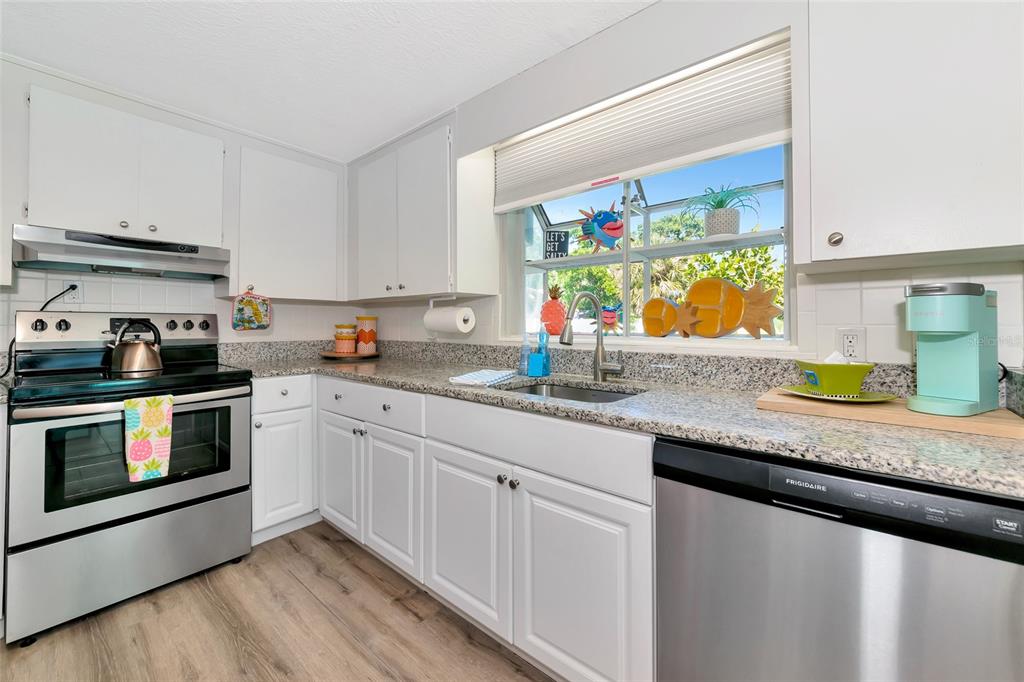 5948 Mirror Lake Road Sarasota, FL 34233 - Photo 25 of 50 a kitchen with stainless steel appliances granite countertop a sink and a stove