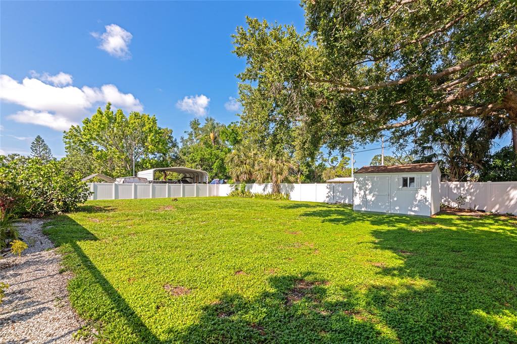 5948 Mirror Lake Road Sarasota, FL 34233 - Photo 36 of 50 a view of a house with a big yard