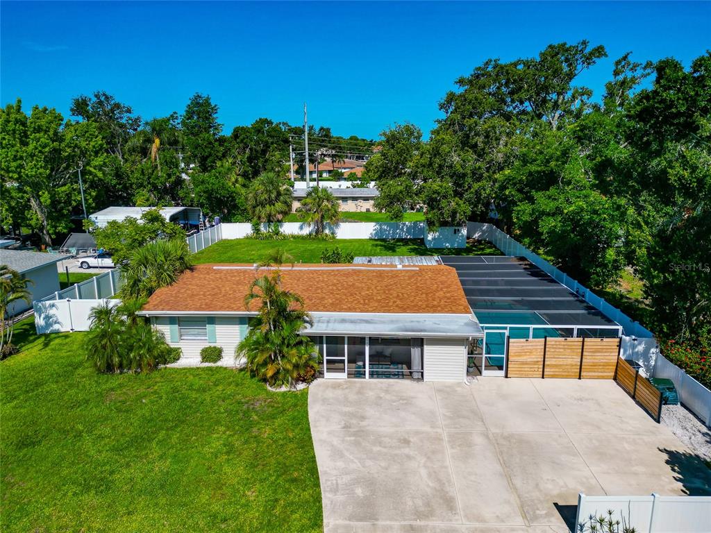5948 Mirror Lake Road Sarasota, FL 34233 - Photo 40 of 50 a view of house with garden space and trees around