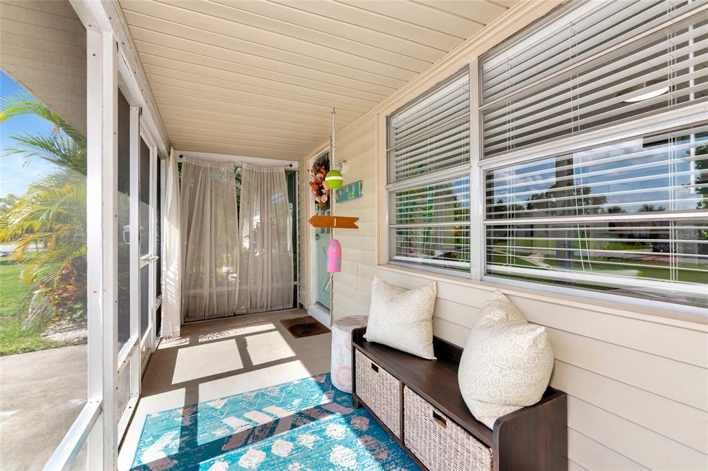5948 Mirror Lake Road Sarasota, FL 34233 - Photo 7 of 50 a balcony with furniture and a potted plant