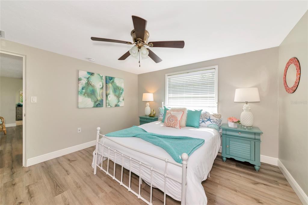 5948 Mirror Lake Road Sarasota, FL 34233 - Photo 10 of 50 a bedroom with a bed and a chandelier