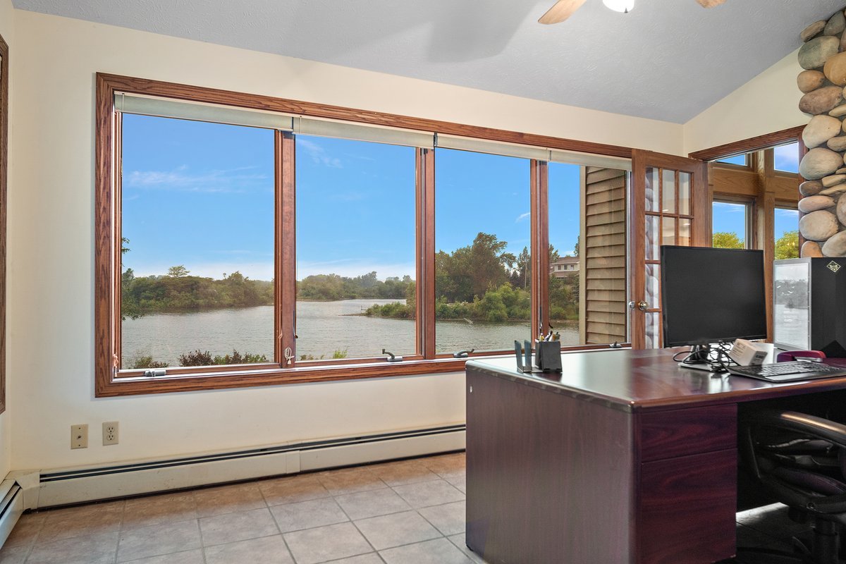 10739-451 North 1300 E Road Chenoa, IL 61726 - Photo 18 of 55 a living room with couches a flat screen tv and a floor to ceiling window