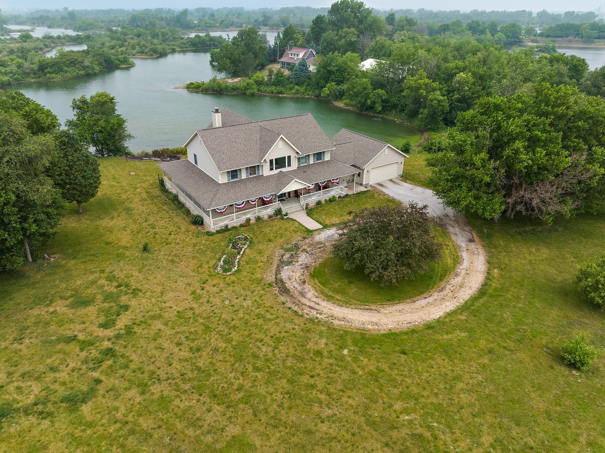 10739-451 North 1300 E Road Chenoa, IL 61726 - Photo 2 of 55 an aerial view of a house with swimming pool and lake view